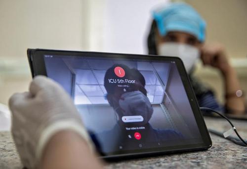 تلاش برای برقراری ارتباط تصویری با یک مادر بزرگ بستری در بخش آی سی یو در بیمارستانی در شهر دهلی هند
